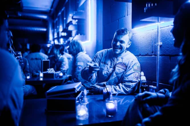 a man laughing in Roscorp Laboratories at the Avora cocktail experience