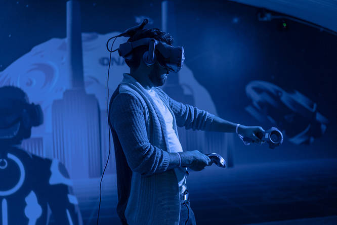 A man playing an immersive game at a VR experience in London
