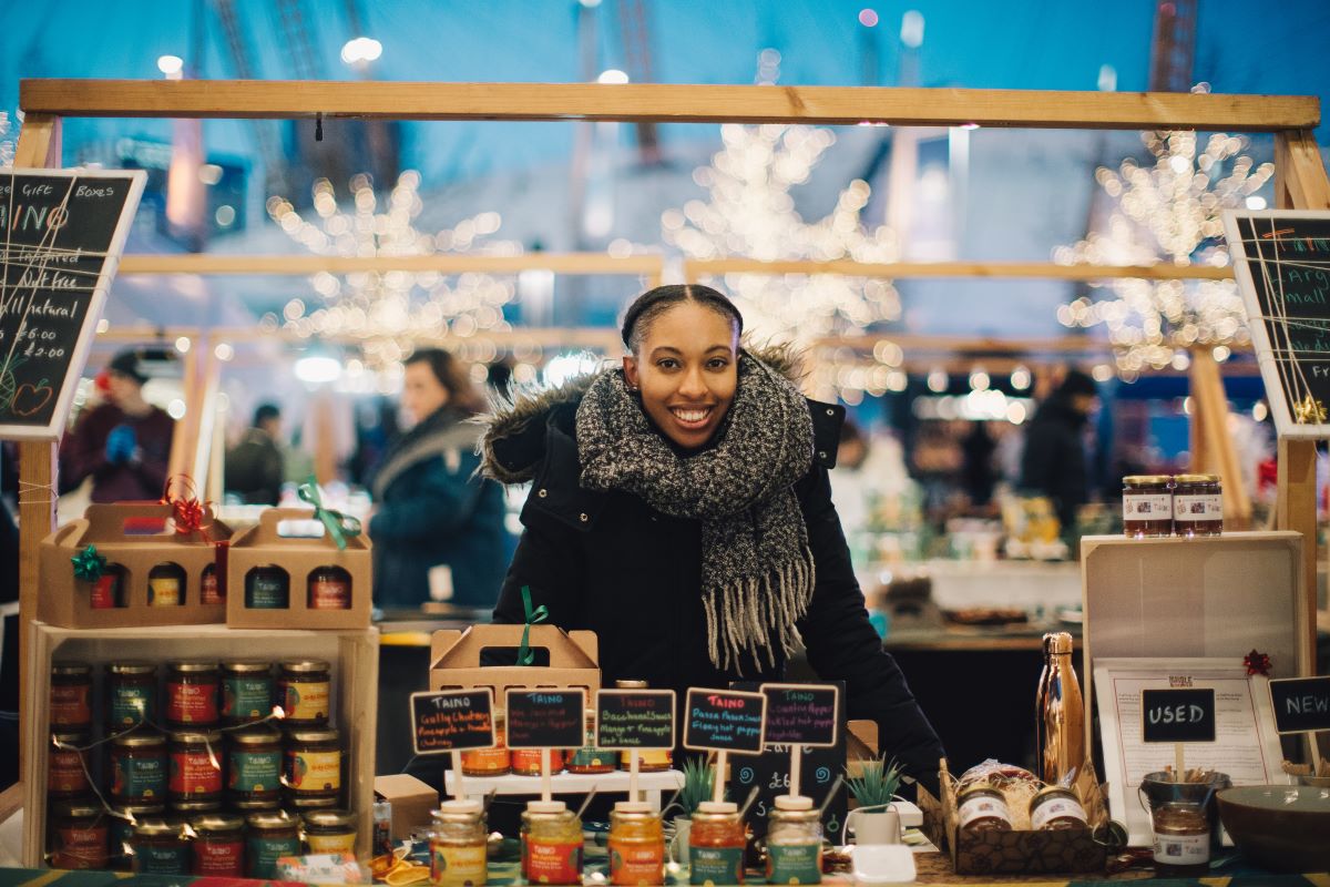 A stall owner at her stall at the Greenwich Christmas Market