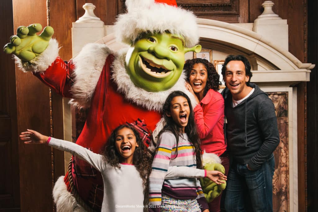 A picture of Shrek with a family at Shrek's Immersive Adventure