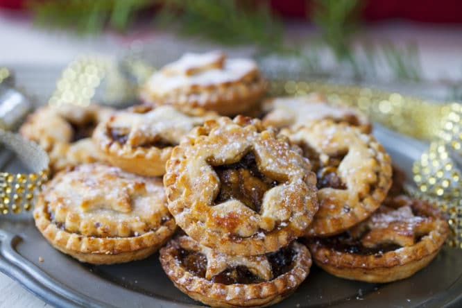 A delicious plate of warm and sugar-covered mince pies