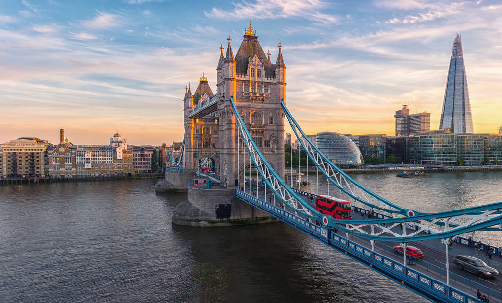 An aerial shot of Tower Bridge and The Shard at sunset in London Bridge.