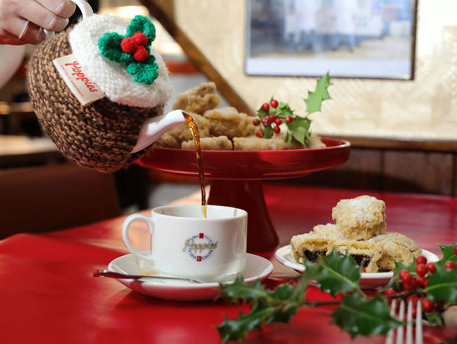 Deep fried mince pies being served alongside a cup of tea